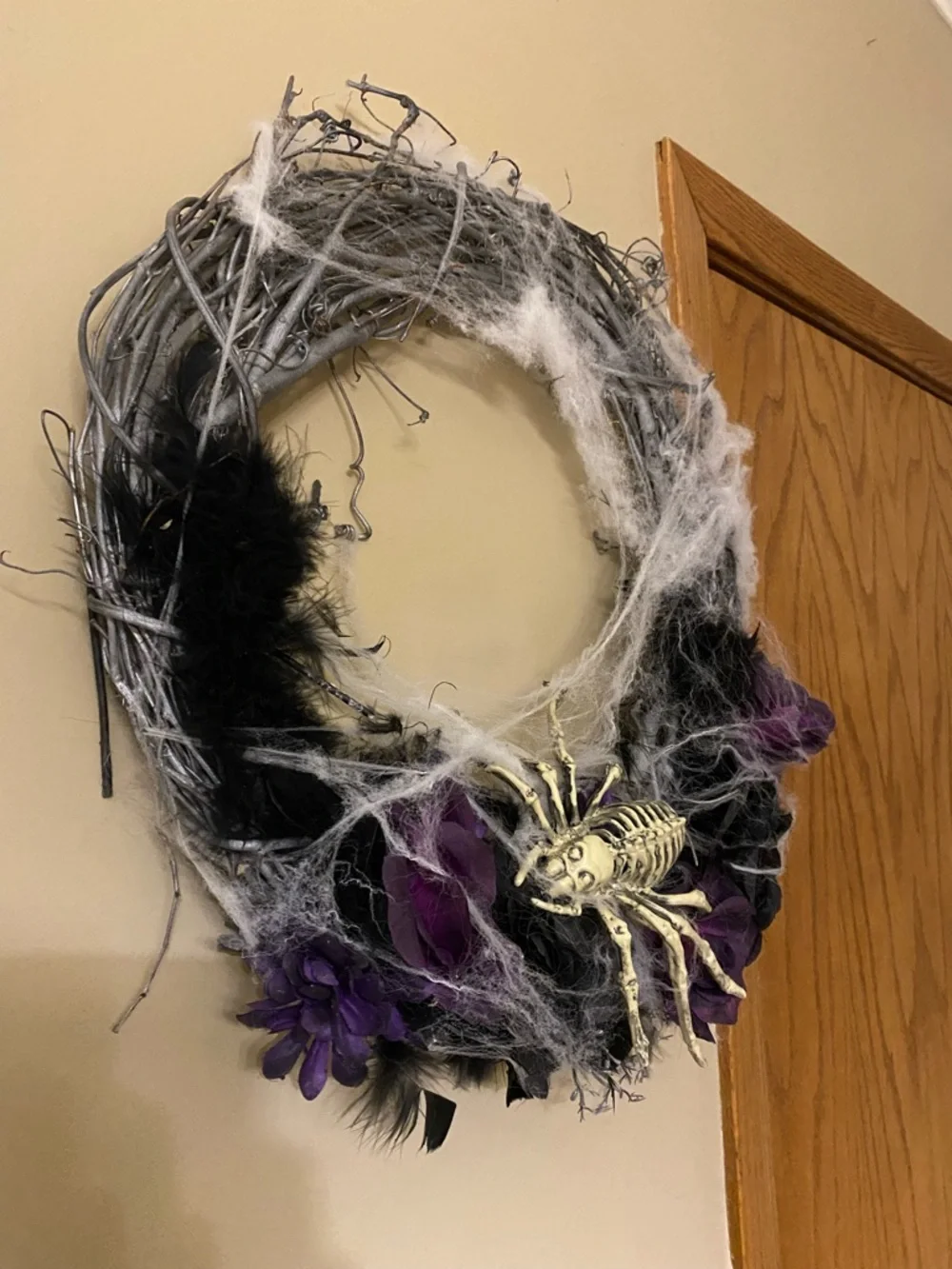 Halloween wreath with spider skeleton, flowers and cobwebs